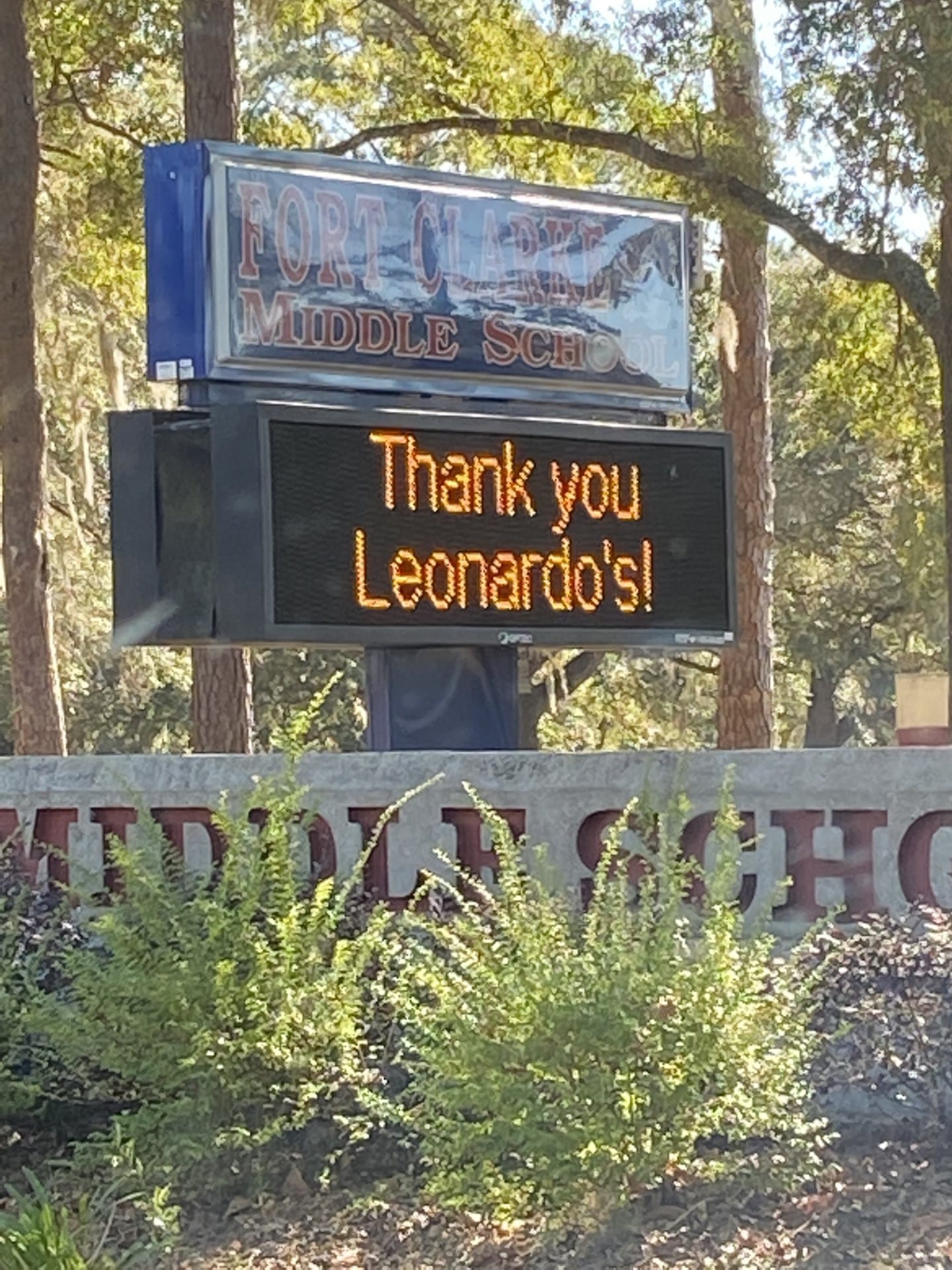 A digital sign in front of Fort Clarke Middle School displays the message "Thank you Leonardo's!"